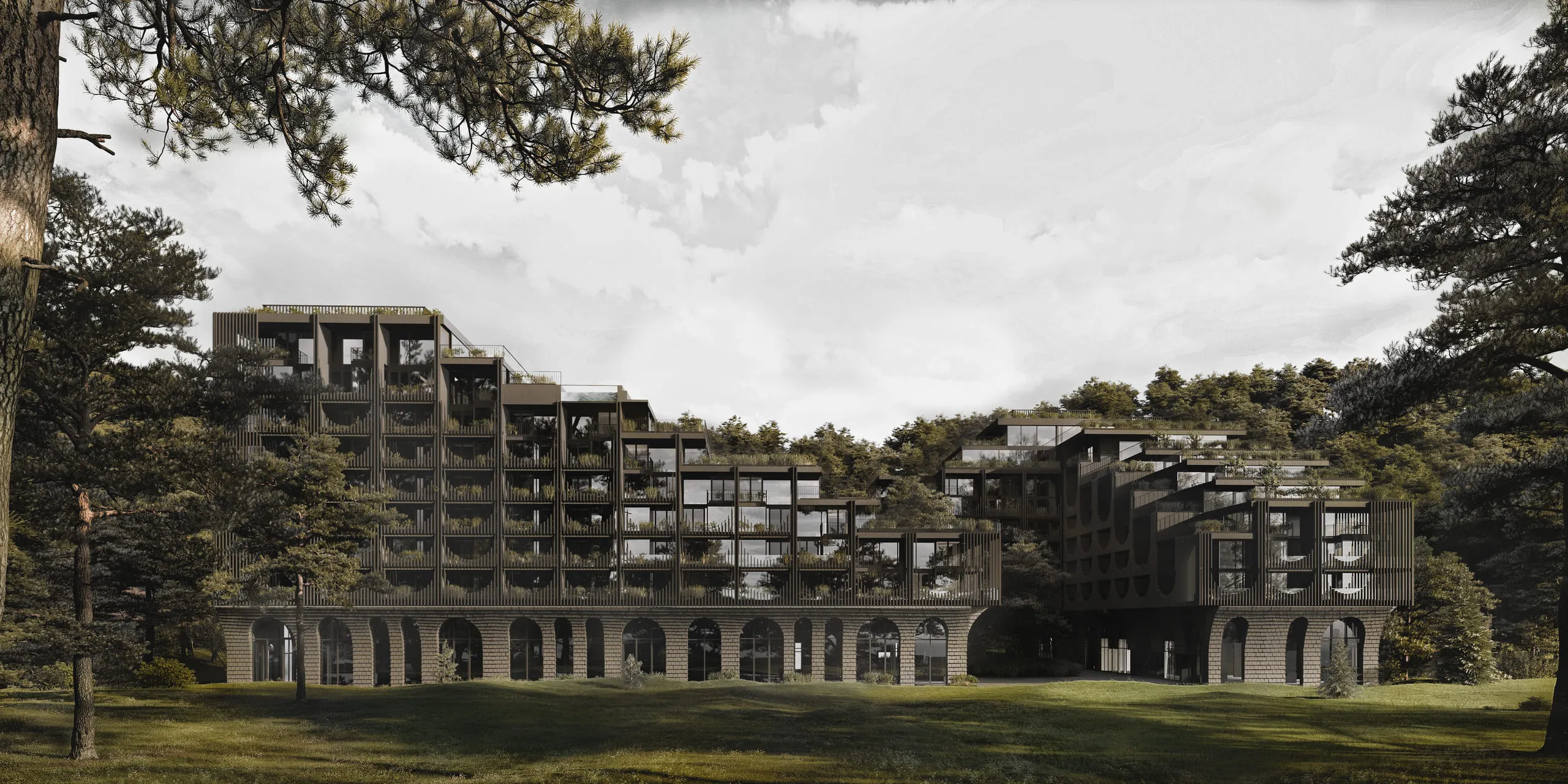 A modern multi-storey building with large arches on the ground floor and trees on the balconies, set among green trees and lawn.