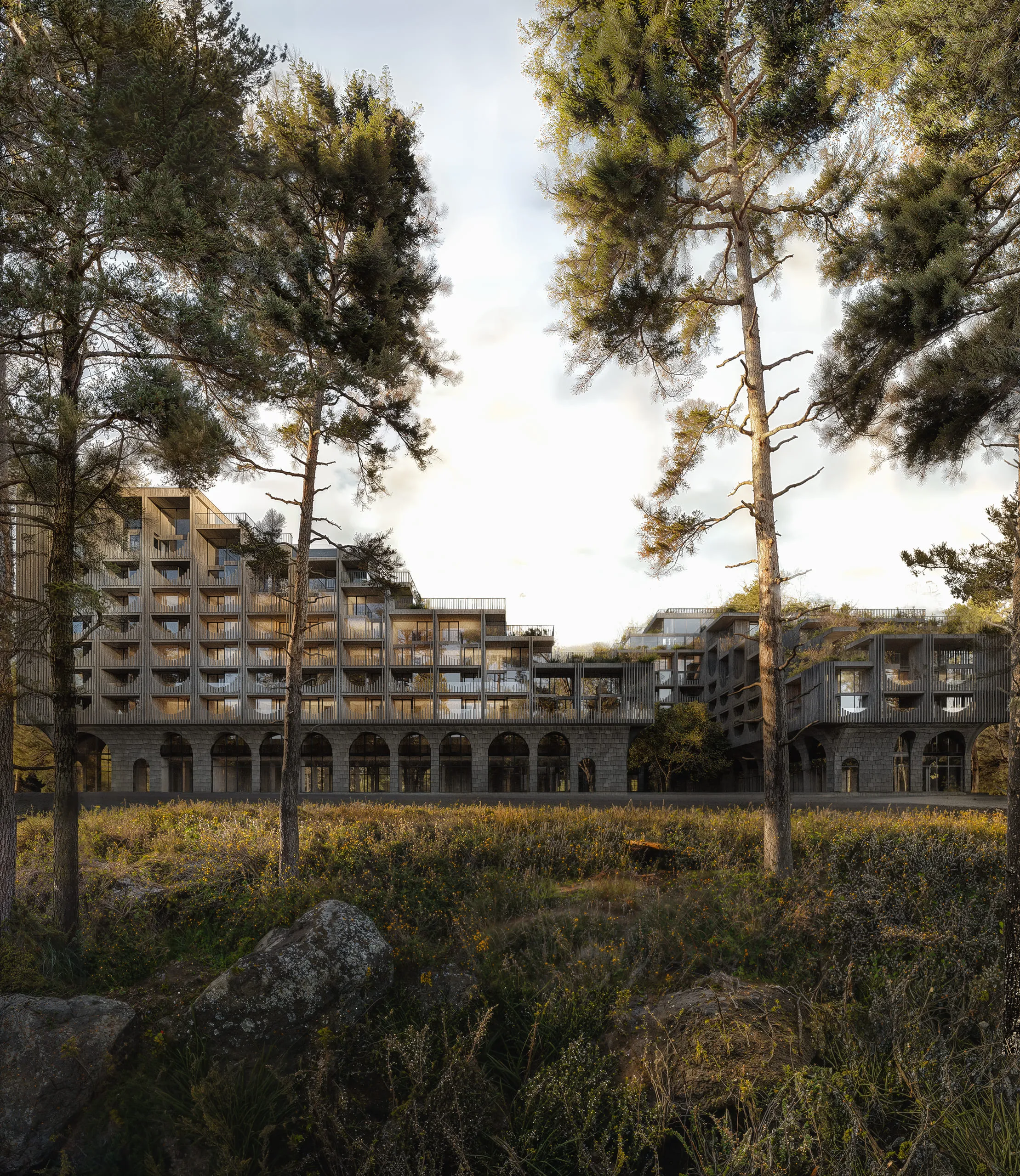 Modern architecture of a high-rise building with arched columns among trees and nature.